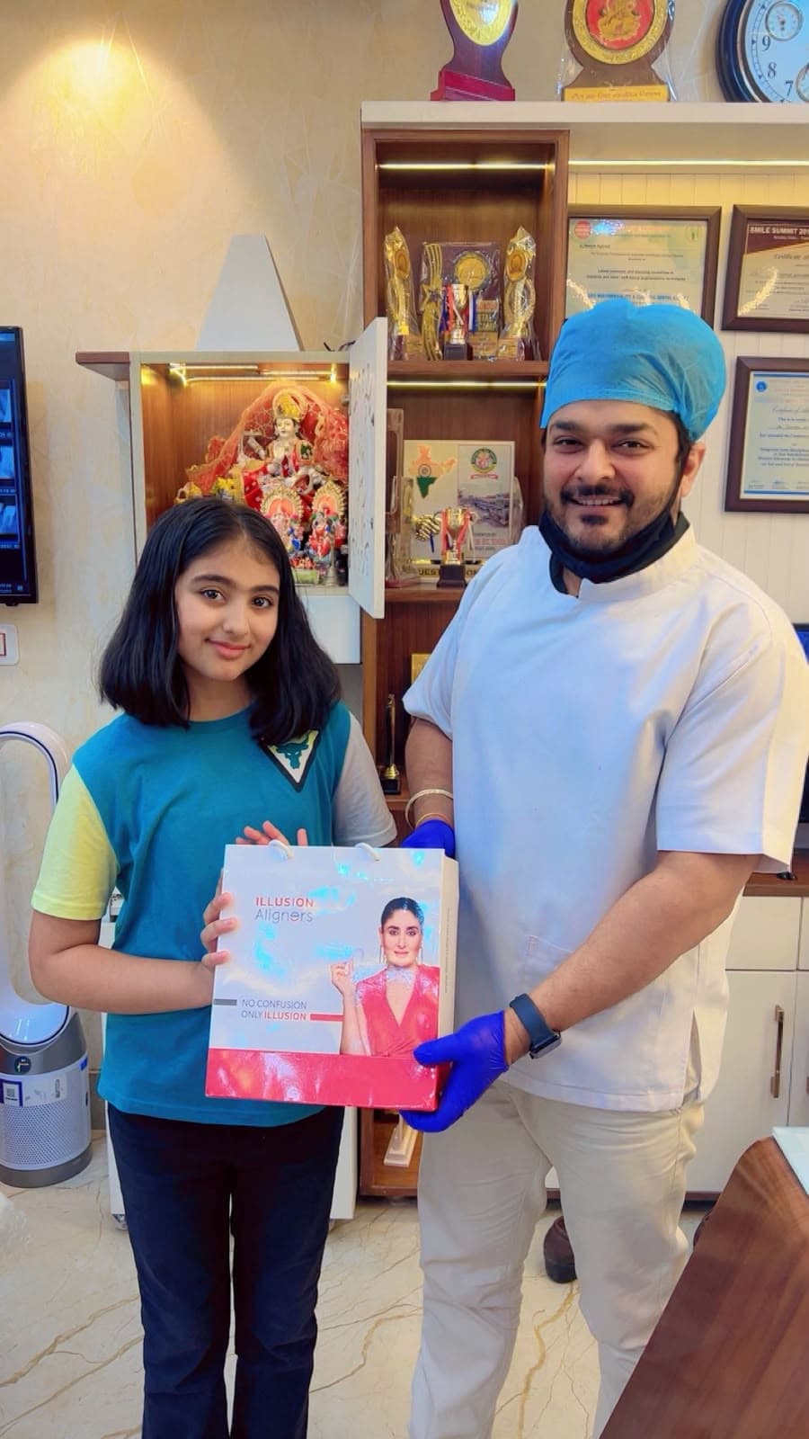 Dr. Deepak Agarwal presenting clear aligners treatment kit to patient