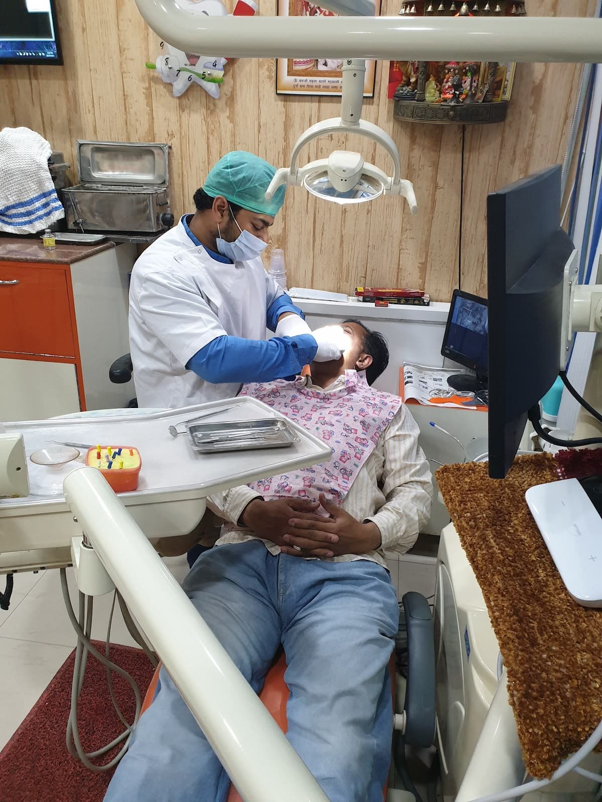 Dr. Deepak Agarwal performing delicate dental procedure chairside