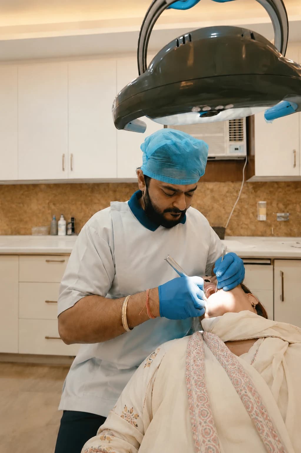 Dr. Deepak Agarwal treating a dental patient chairside at Agarwal Dental Clinic